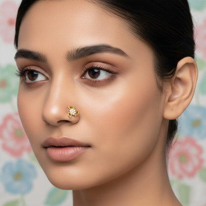 Floral nose pin in 9K yellow gold with twisting petals and small diamonds