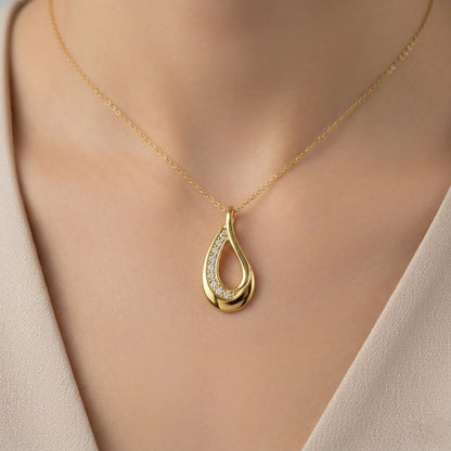 Graceful teardrop sweep diamond gold pendant