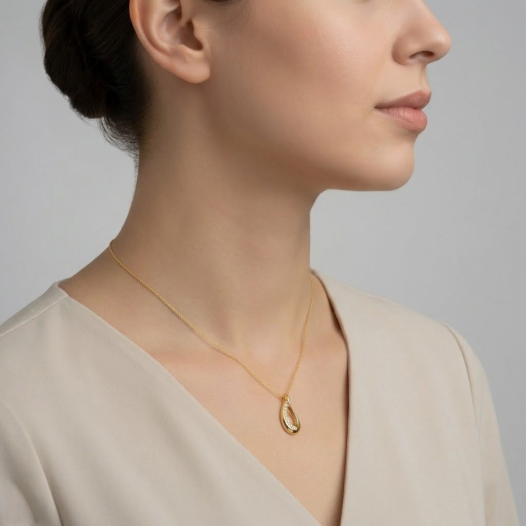 Graceful teardrop sweep diamond gold pendant