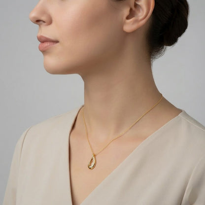 Graceful teardrop sweep diamond gold pendant